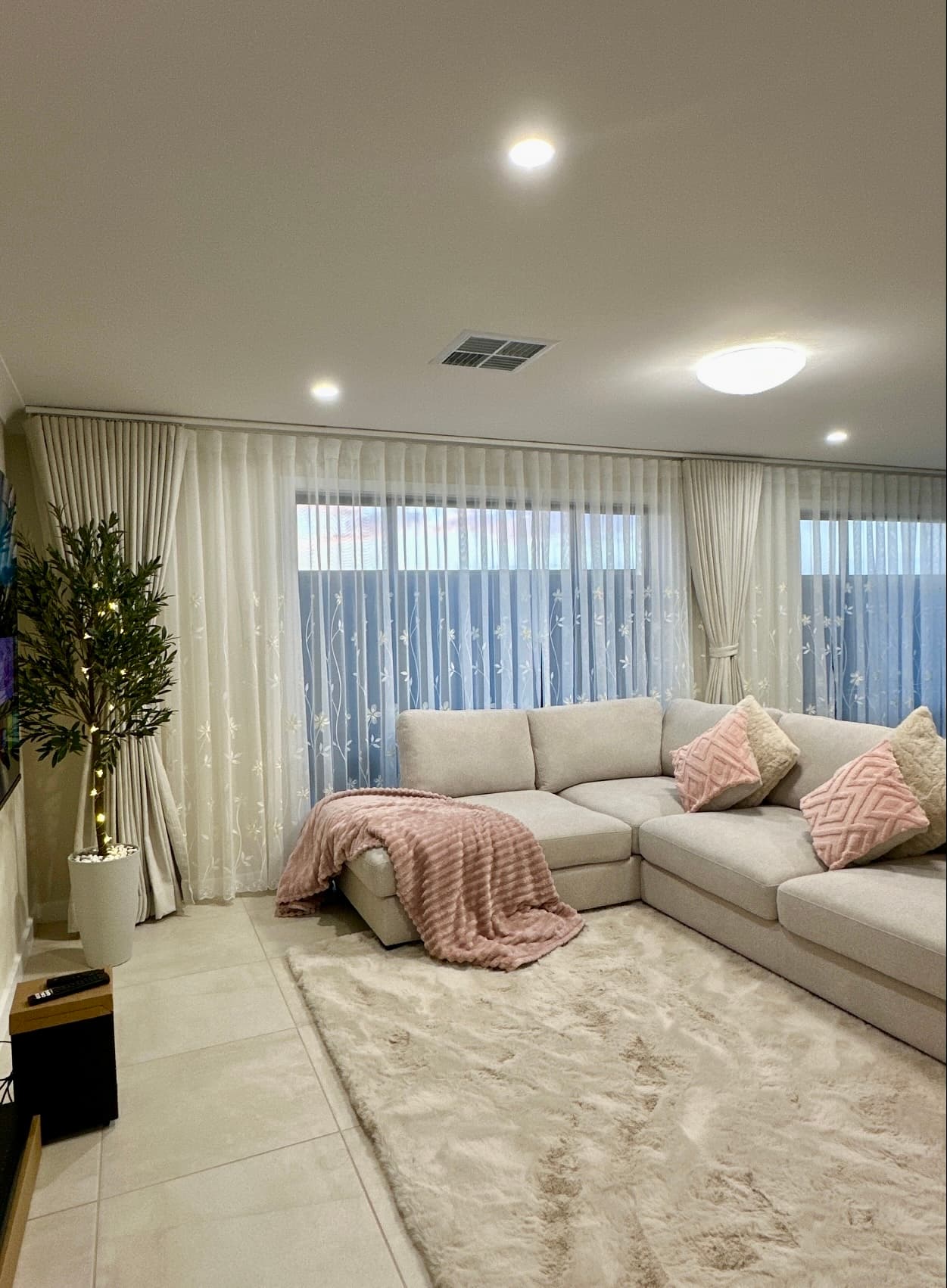 Custom-tailored curtains in a styled living room